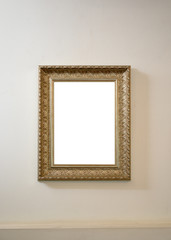 Antique gilded blank picture frame on wall