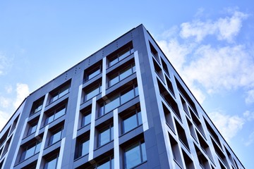 Modern office building facade abstract fragment, shiny windows in steel structure