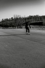Teenager man on skateboard practicing at the park making jump and perform stunts  in spring autumn...