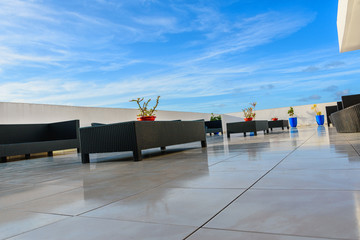 Wicker furniture on a concrete terrace of modern house
