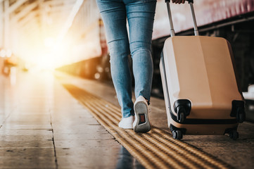 Traveler tourist walking with luggage at train station