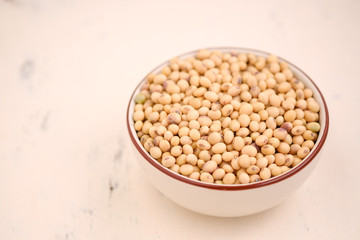 Soy bean in bowl on floor and copy space.soybeans dry on white backdrop.