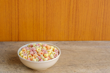 Cereal flakes in bowl with copy space,Breakfast concept.Food with delicious fruity taste and fruity colours.It's made with maize,wheat,and barley.topview and copy space.white background