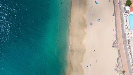 Top View on Coast of Atlantic Ocean, waves on beach aerial view, crystal clear water in Morro Jable Fuerteventura. 