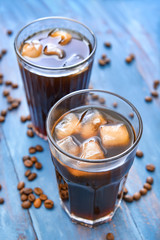 Glasses of tasty iced coffee on table