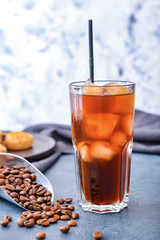 Glass of tasty iced coffee on table