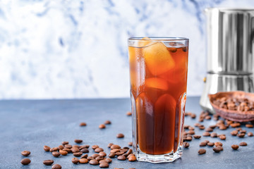 Glass of tasty iced coffee on table