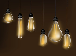 Realistic and colored vintage glowing light bulbs transparent set with included lamps in loft style vector illustration © saliyeri