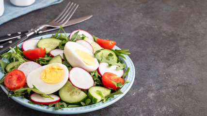Healthy and diet salad with fresh vegetables on a plate. Copy space
