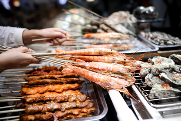 Shrimps on wooden sticks for grilling.