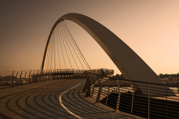 Futuristic Pedestrian Bridge over the Dubai Water Canal at sunset 
