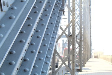 Structural elements of an old steel bridge. Arches and farms riveted.