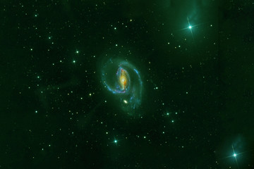 Naklejka na ściany i meble A green galaxy in deep space. Elements of this image were furnished by NASA.
