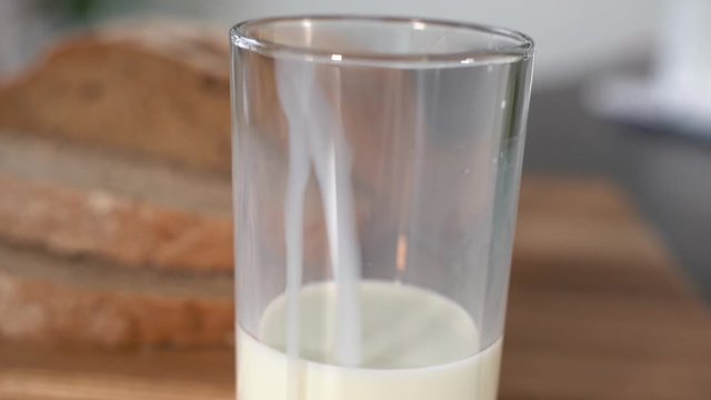 Drops of milk from bottle to glass