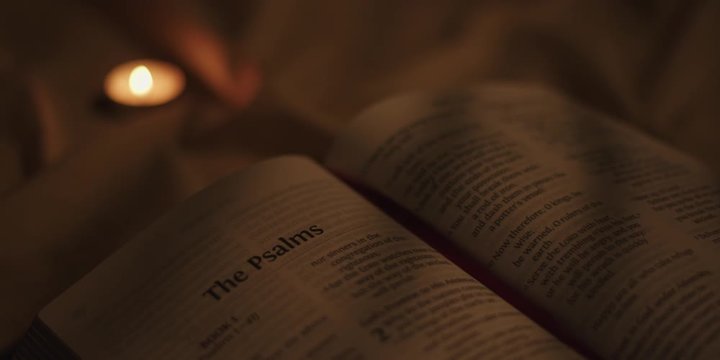Open bible with candle 