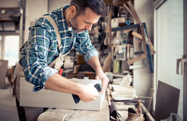 Carpenter working on woodworking in carpentry workshop