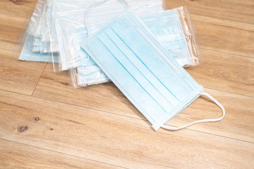 Surgical mask with rubber ear straps. Typical 3-ply surgical mask to cover the mouth and nose. Procedure mask from bacteria. Protection concept.