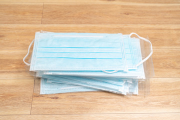 Surgical mask with rubber ear straps. Typical 3-ply surgical mask to cover the mouth and nose. Procedure mask from bacteria. Protection concept.