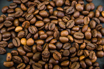 coffee beans on a black background. Background with grains.
