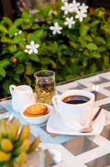 cup of tea and flowers on wooden table