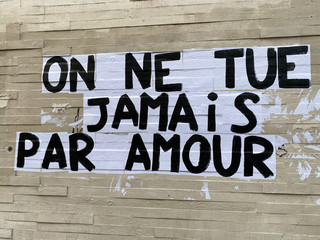 Protest poster against domestic violence and femicide stuck on a wall in Paris France, saying 