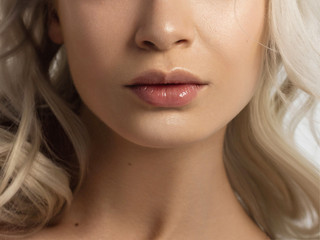 Sexual full lips. Natural gloss of lips and woman's skin. The mouth is closed. Increase in lips,...