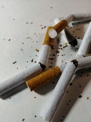 broken cigarettes as a symbol of a healthy lifestyle on a white background