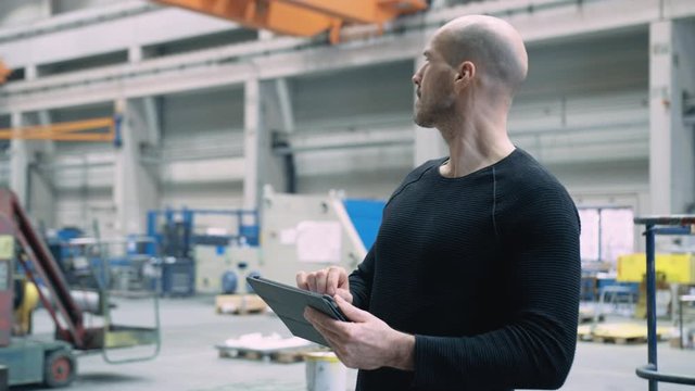 Engineer working with tablet in the factory