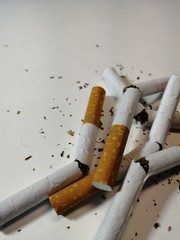 broken cigarettes as a symbol of a healthy lifestyle on a white background