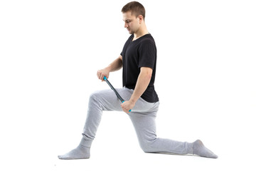 A man makes strengthening exercises for the body with special sports equipment. Self massage increases the body's tone