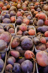 Containers of colorful beets at a farmers market
