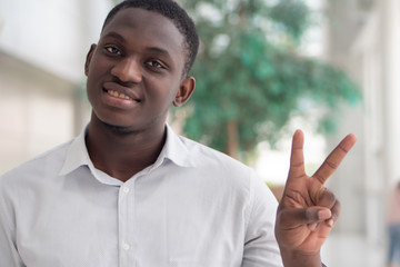 Black African business man showing V for Victory sign or pointing, counting number 2