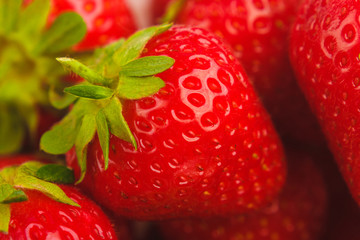 Red ripe strawberry in the white bowl, light background