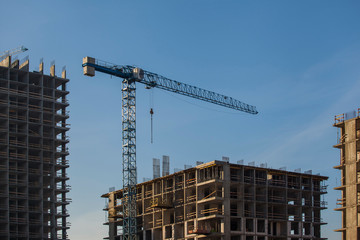 Construction site with crane against the blue sky	