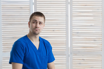 Portrait of a young male doctor in a medical office