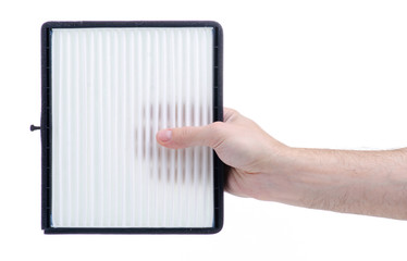 Hand holding cabin air filter auto on white background isolation
