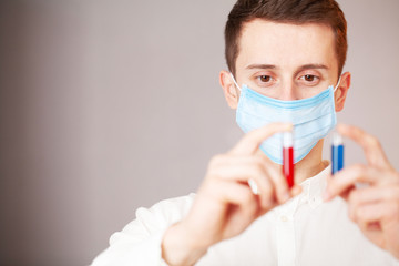 Health worker holds a test tube with a test of covid-2019