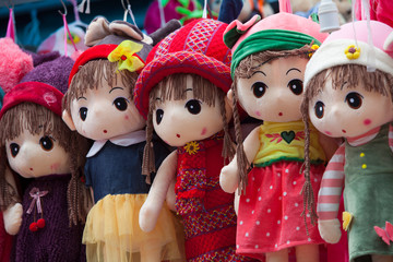 Colorful puppets hanging for sale at an old street 