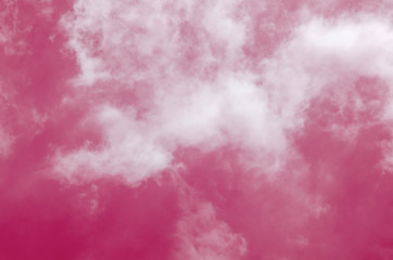 Pink sky with white clouds and blurred pattern background