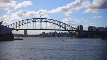 Fototapeta na wymiar Sydney Harbour on a warm summer afternoon at Sunset blue skies and white orange clouds