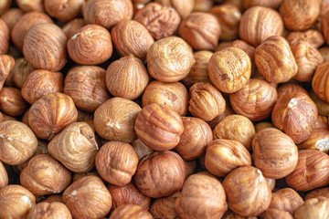 Background image of a pile of hazelnuts