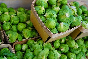 Containers of fresh organic green Brussels sprouts at the farmers market