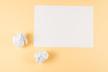White empty sheet of paper on beige background.