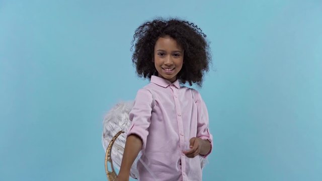 african american kid with angel wings and crossbow isolated on blue