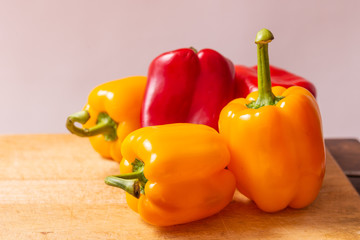 Red and yellow fresh sweet peppers on white background. Healthy ingredients, summer food