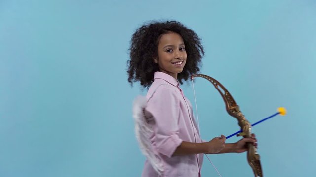 happy african american cupid with crossbow isolated on blue