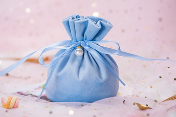 A gift bag made of silk, on a pink background