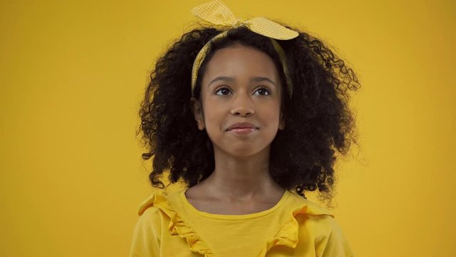 cheerful african american kid smiling isolated on yellow