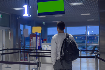 A man at the airport, one is landing, VIP registration. The man was late to the airport. How much do you need to go to the airport. A man with a backpack at the airport. green tv
