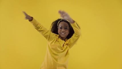 happy african american kid dancing isolated on yellow